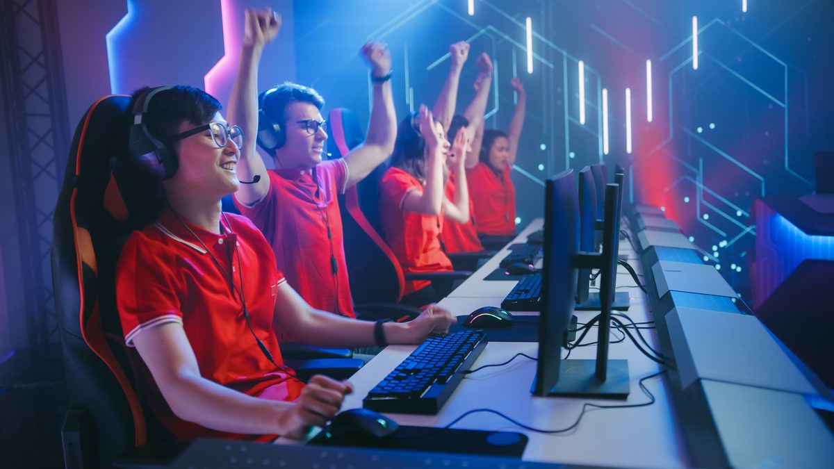 Esports team celebrating a win at their stations